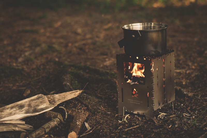 stainless-steel-pot-on-brown-wood-stove-outside-during-night-time-px _ potable water