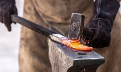 Blacksmith working on metal on anvil | Blacksmithing Guide | Ultimate Guide to Blacksmithing For Beginners | Featured