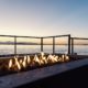 Sunset in the backyard by the fire pit and the sea | How to Choose the Best Propane Fire Pit for You | Top 9 Propane Fire Pits on the Market | featured