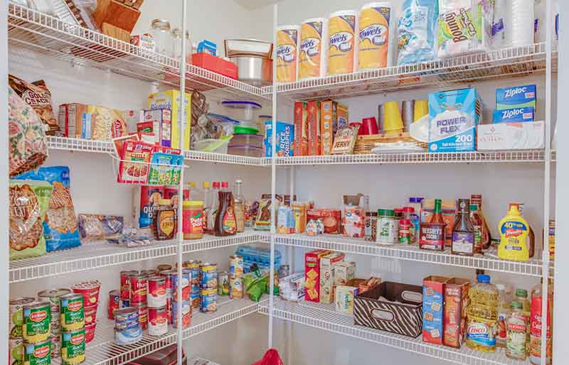 large pantry stocked with food and paper products | how to build a bunker