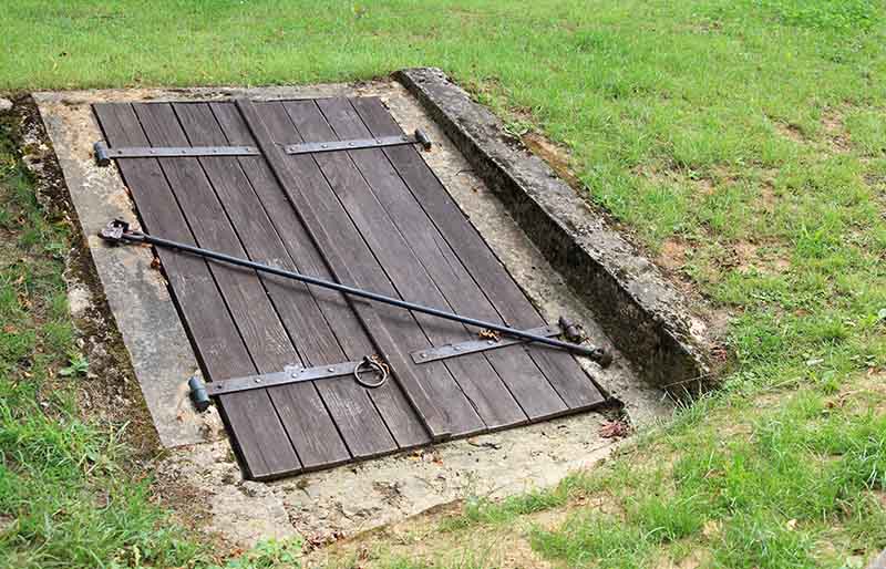 old closed wooden entrance underground cellar | how to build a bunker