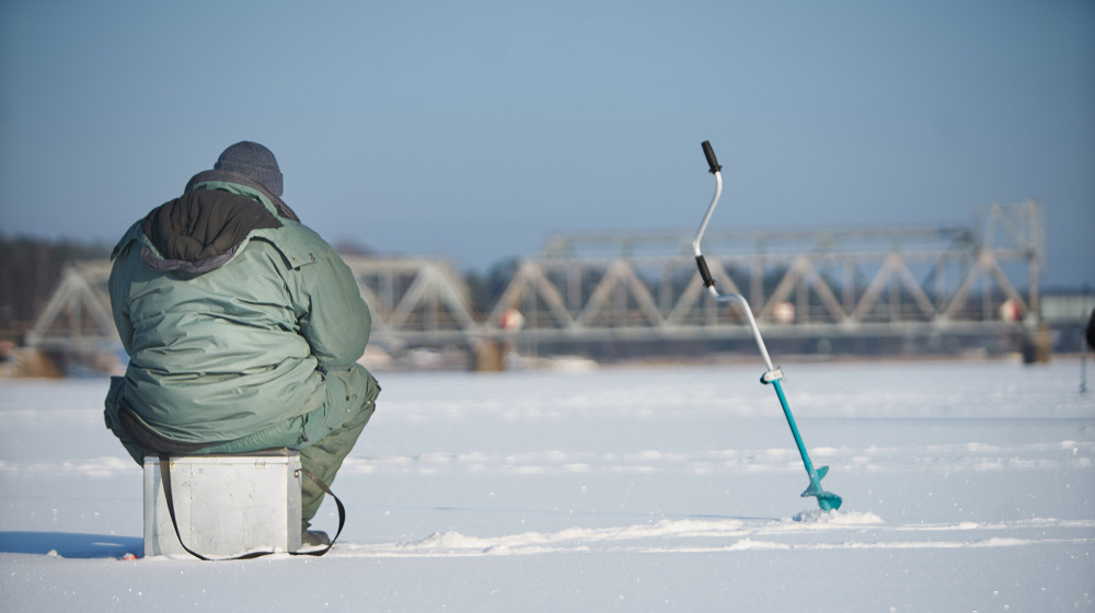 Fisherman enjoying a days fishing on the ice | Ice Fishing 101 | Everything You Need To Know | featured