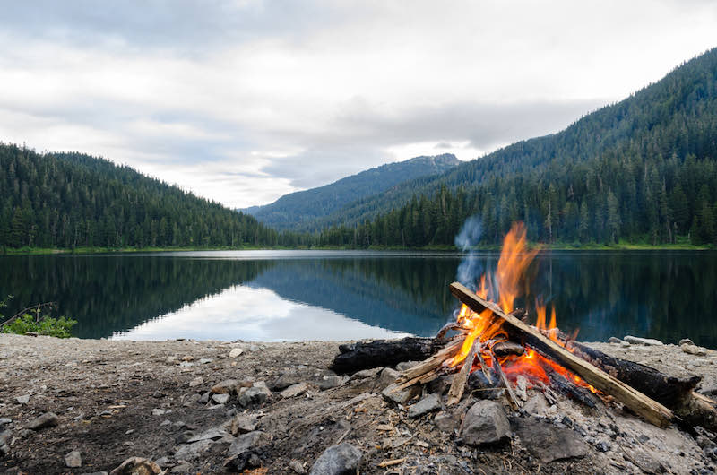 Landscape of a campfire in a peaceful lake valley | Bow drill kit