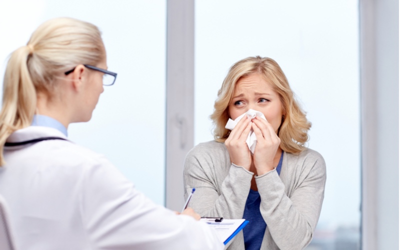 doctor and ill woman patient with flu at clinic | spring allergies | Consult your doctor