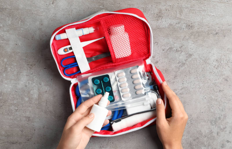 woman first aid kit on gray | wilderness first aid