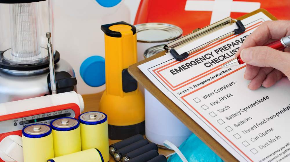 Hand completing Emergency Preparation List by Equipment | Prepare Your Family for Emergencies | Featured