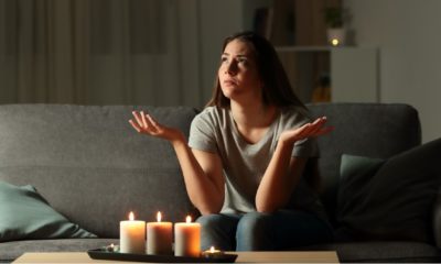 What to Do in a Power Outage | Woman complaining during a blackout sitting on a couch in the living room at home-Power Outage | Featured