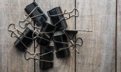 Binder Paper clip on old wooden background | INNOVATIVE WAYS TO USE BINDER CLIPS FOR SURVIVAL | Featured