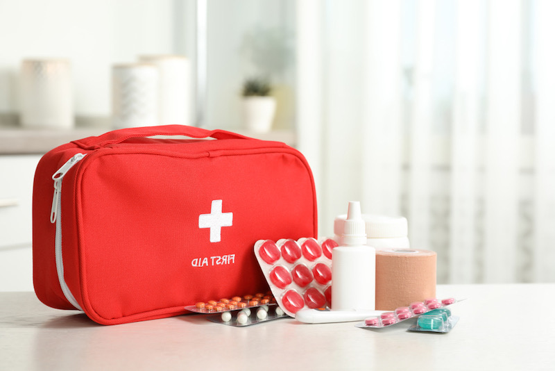 First aid kit with pills on table indoors | emergency bag checklist