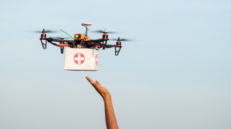 Hands reciving medical aid kit or medicins from drone or quadcopter during covid-19-IFAK