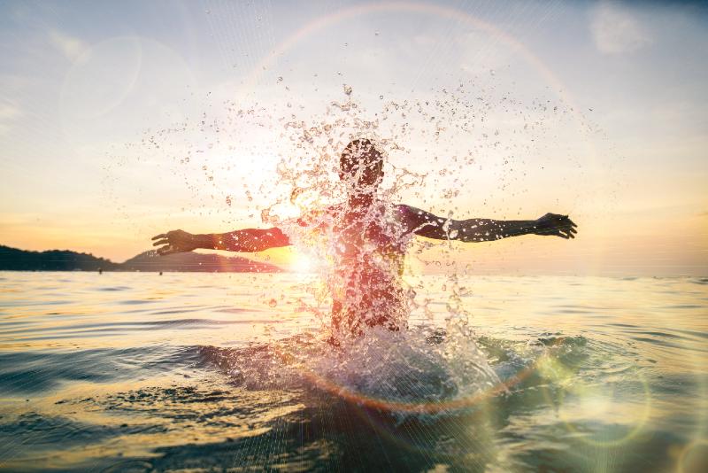 Man splashing water during summer holidays-sea survival