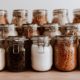 Air tight glass jars filled with rice and pasta and basic ingredients | Basic Survival Food Storage On a Budget | featured