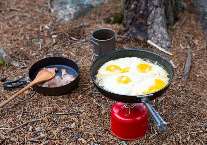 Breakfast bacon and fried egg on a titanium plate Camping checklist SS