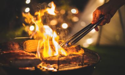 Family making barbecue in dinner party camping at night | 23 Best Camping Recipes | Featured