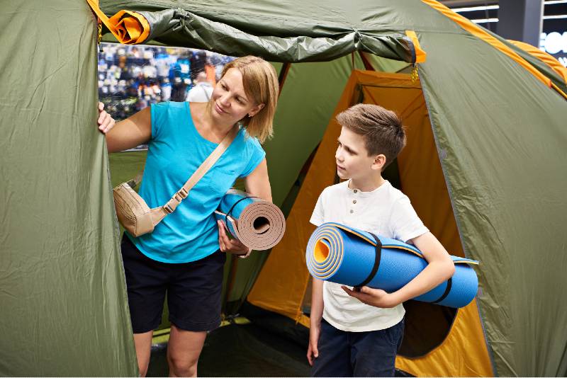 Mom and son choose a camping tent in store | camping tent | featured