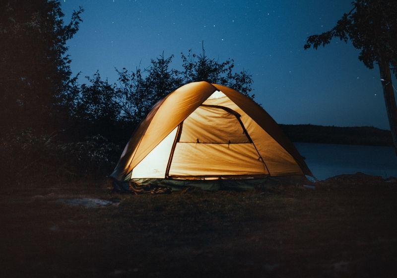 Photo of tent at near trees | Tips to Help You Camp in the Rain