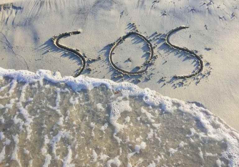Text sos help on the sand on the beach Car camping essentials SS