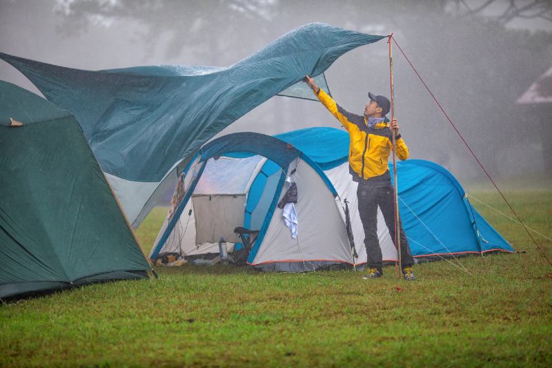 Travelers are repairing tents During the rainy-Camping In The Rain
