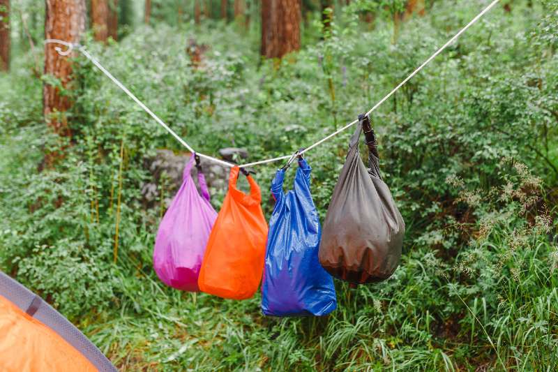 Waterproof dry bags in camping in mountains-Camping In The Rain