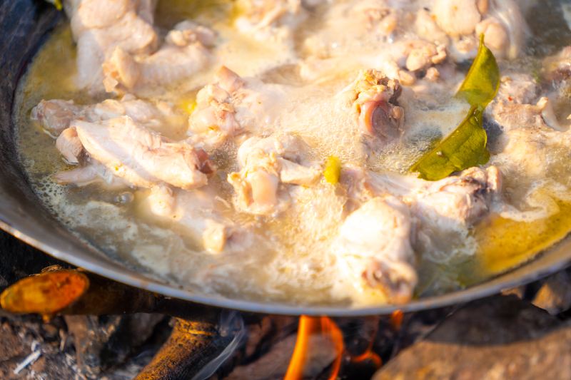 chicken spicy soup in pan on camping on hills-healthy camping meals