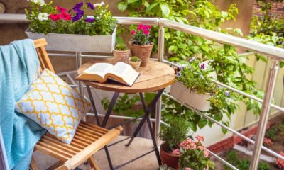 Beautiful terrace or balcony with small table, chair and flowers | 8 Cheap Options to Create a Small Space Garden | featured