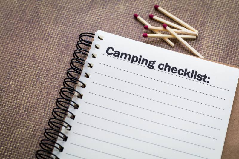 Camping checklist concept on notebook with matches-Simple Packing Tips
