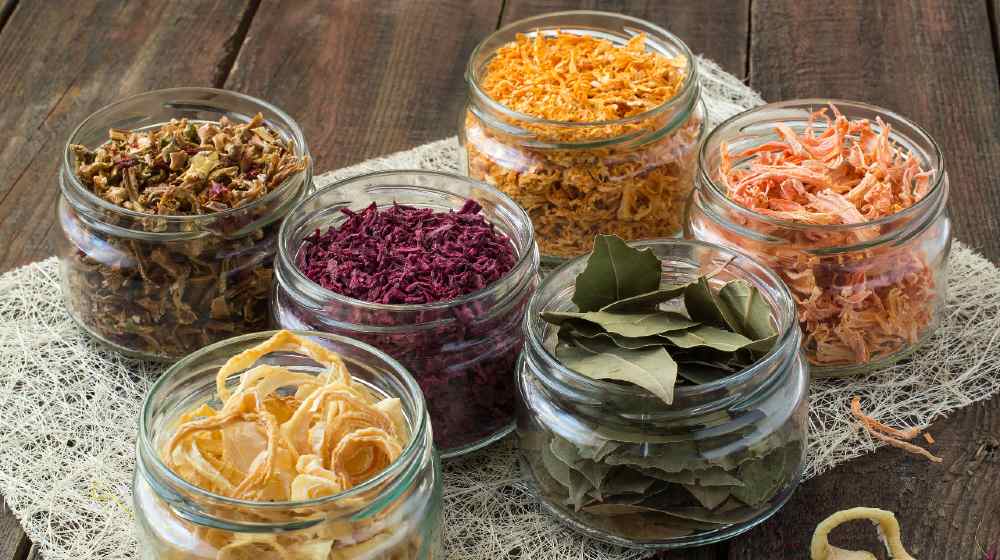 Dried vegetables (onions, beets, carrots, pumpkin, bay leaf) banks on straw napkin | The Top Foods to Dehydrate to Survive Long Term | featured