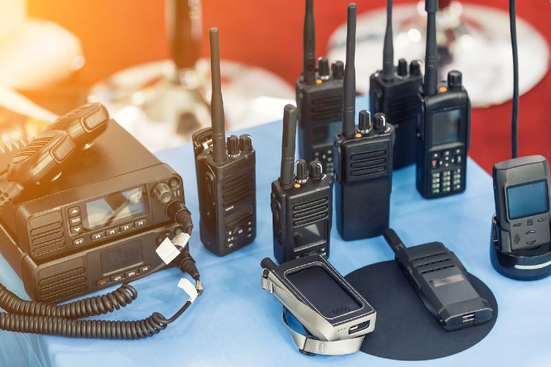 Many portable radio transceivers on table at technology exhibition-Emergency Radios