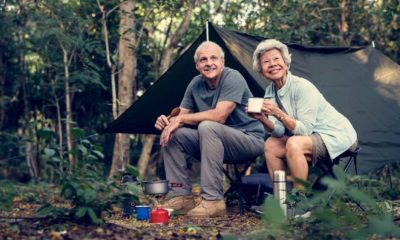 Senior friends having coffee at a campsite | 3 Useful Tips For Camping With Seniors | featured