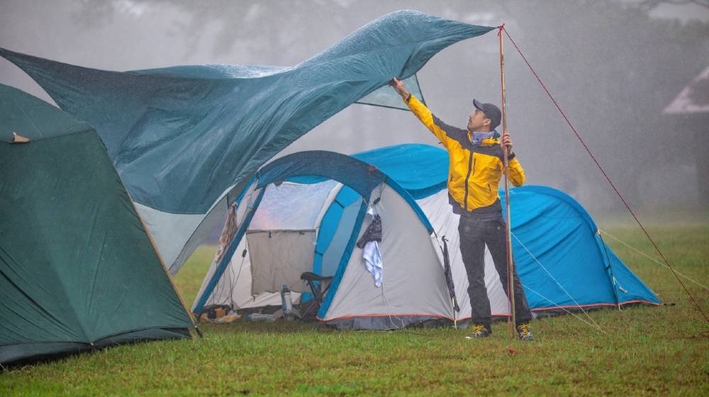 Travelers are repairing tents During the rainy Camping In The Rain ss featured