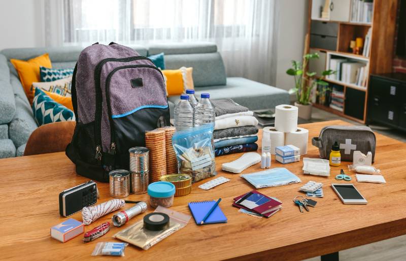 Emergency-backpack-equipment-organized-on-the-table-in-the-living-room-Bug-Out-Bag