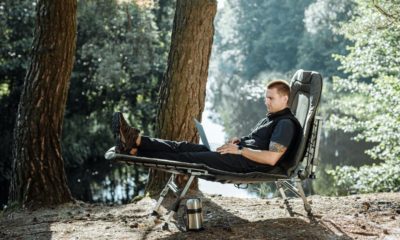 Man sitting white chair | Camping Cots | Featured