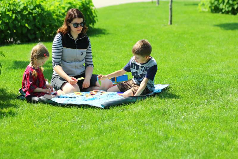 Caucasian-family-playing-board-games-picnic-what-to-bring-for-a-picnic-ss