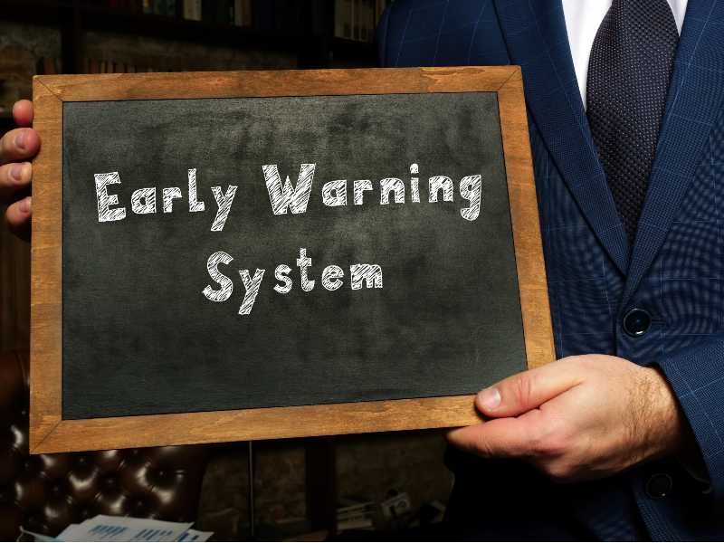 Business concept about Early Warning System with sign on the black chalkboard-Survival Economic Collapse