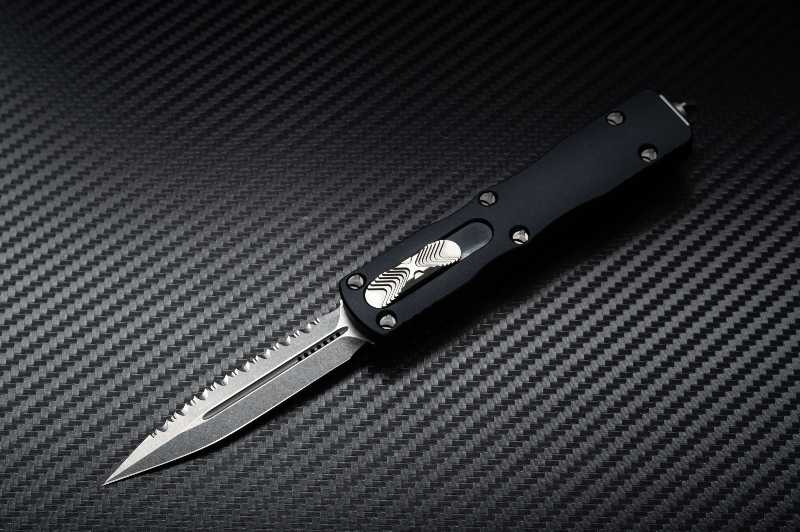 Double sharpened knife.  Black knife on black background - must be looked for in a survival knife