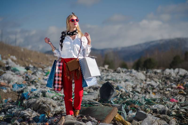 Modern woman on landfill, consumerism versus pollution concept-Survival Economic Collapse