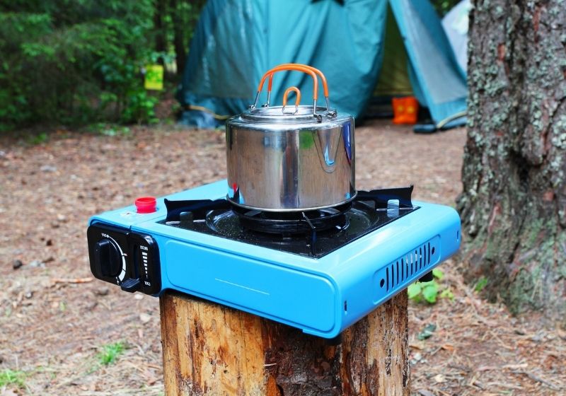 Pot stands on a portable gas slave in tourist camp | Top Best Portable Camping Stoves 