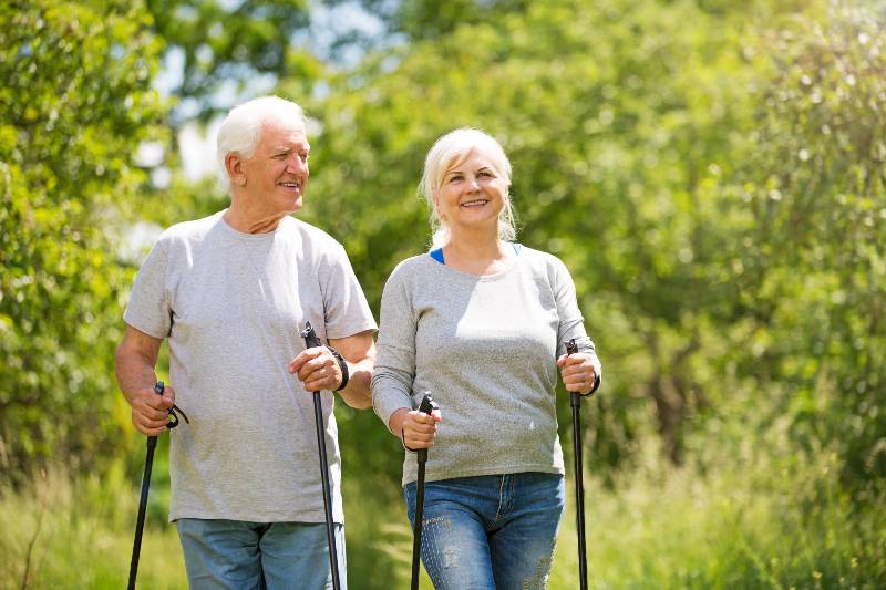Senior couple Nordic walking in the park hiking Safety tips for active seniors