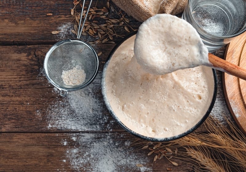 Stirring with a spoon of active starter culture | How To Make Yeast