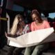 Summer travel concept - Multiracial young friends looking at map-Truck Bed Camping