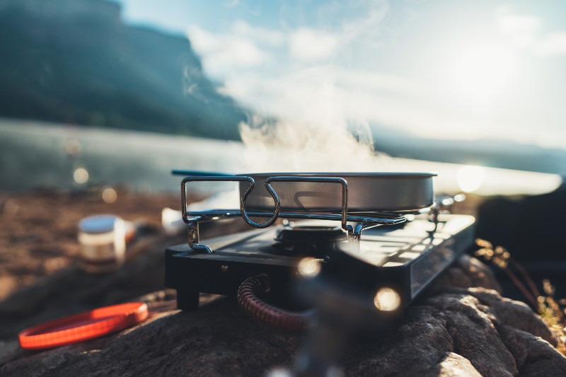 cooking in nature camping outdoor, cooker prepare breakfast picnic on metal gas stove-Truck Bed Camping