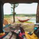 person view couple resting at camping woman laying in hammock with beautiful view of forest lake-Truck Bed Camping
