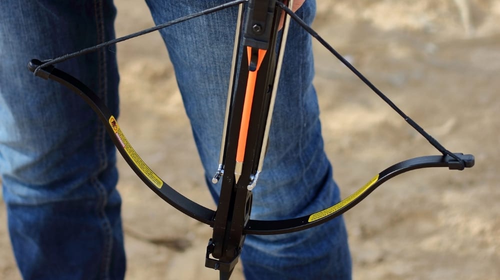 A Man holds a Crossbow Pistol ready for shooting | Pistol Crossbow Reviews | What’s the Best Pistol Crossbow in 2021? | Featured