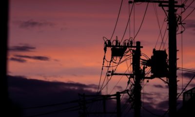 Silhouette of electric post | How to survive a power grid attack | Featured