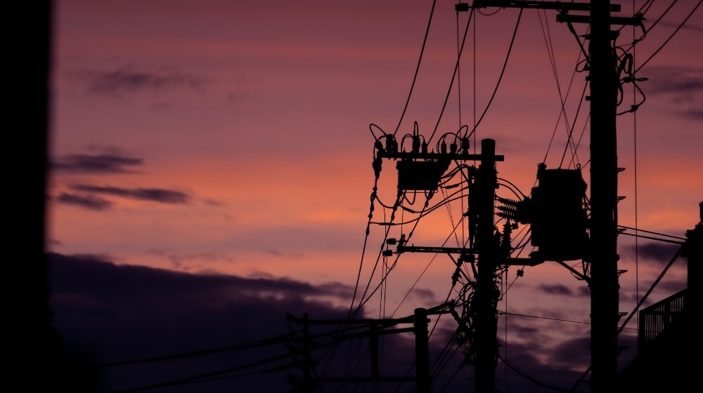 Silhouette of electric post | How to survive a power grid attack | Featured
