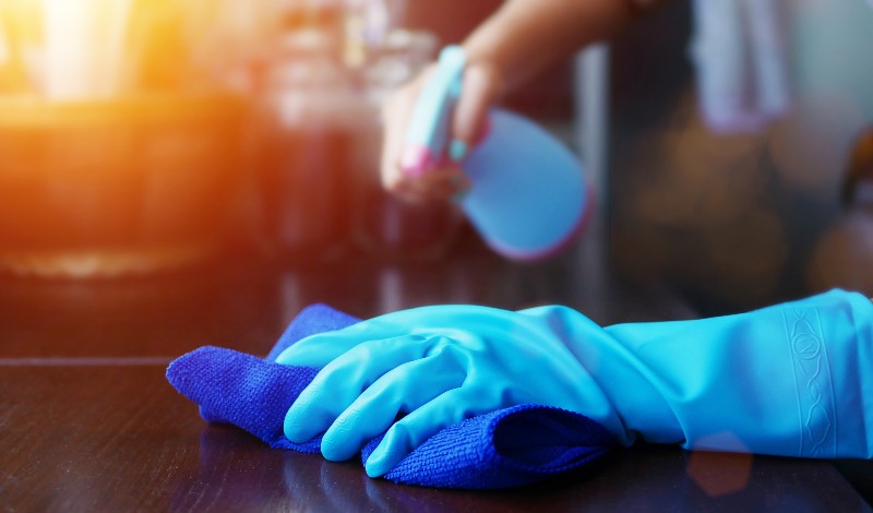 hand in blue rubber glove holding blue microfiber cleaning cloth and spray bottle with sterilizing solution make clean and disinfection for good hygiene-How to Make Mead