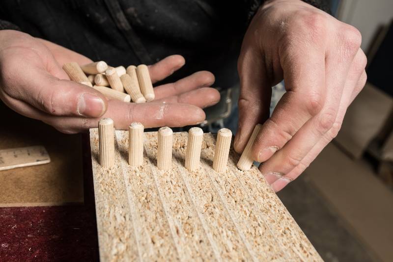 Carpenter hammering wood dowel in a piece of wood | Joining Wood with Dowels