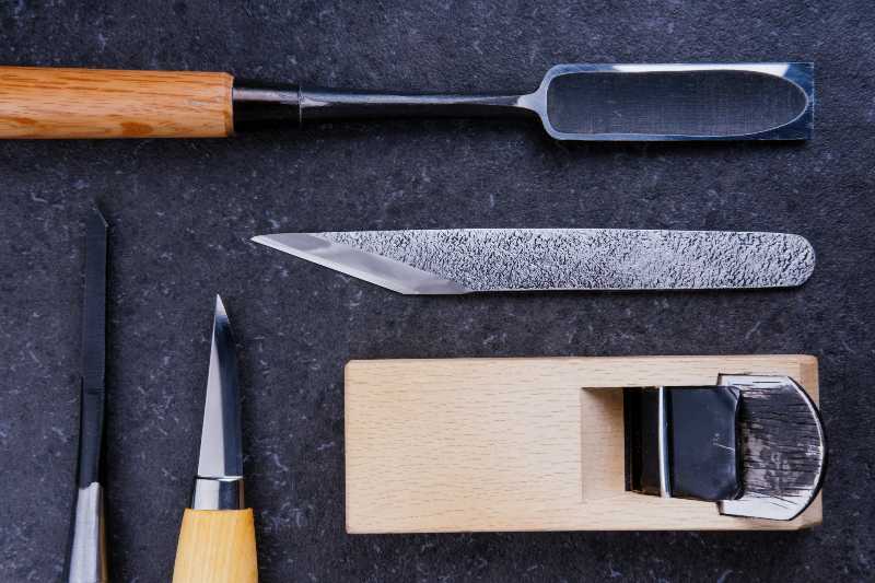 Collection of Japanese carpentry tools on a stone surface | Kumiki