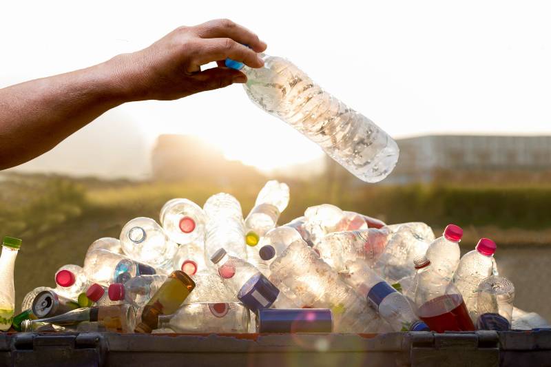 Hand holding recyclable plastic bottle | How to Make a Fish Trap