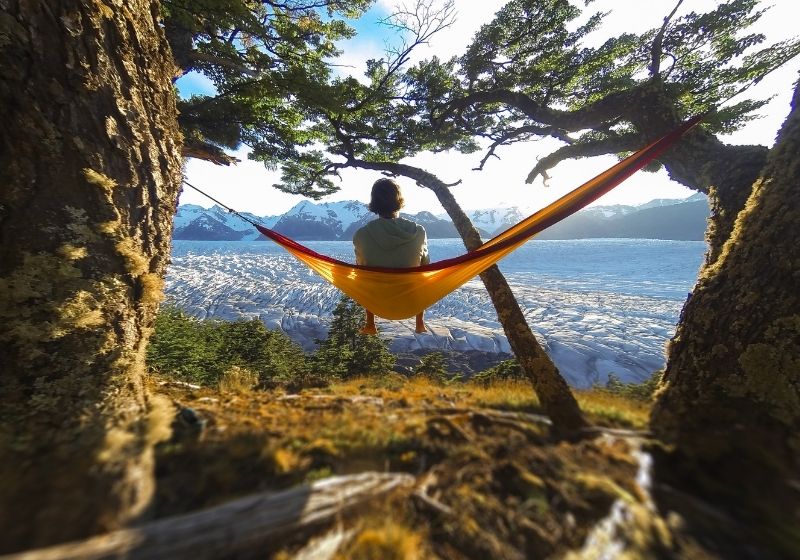 A barefooted young man sits in orange hammock | Homemade Wanderlust Gear List | XX Things You Should Have in Your Appalachian Trail Gear List